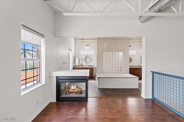 5603 Deer Creek Falls Ct, Las Vegas, NV 89118 - living area featuring wood-type flooring and a multi sided fireplace