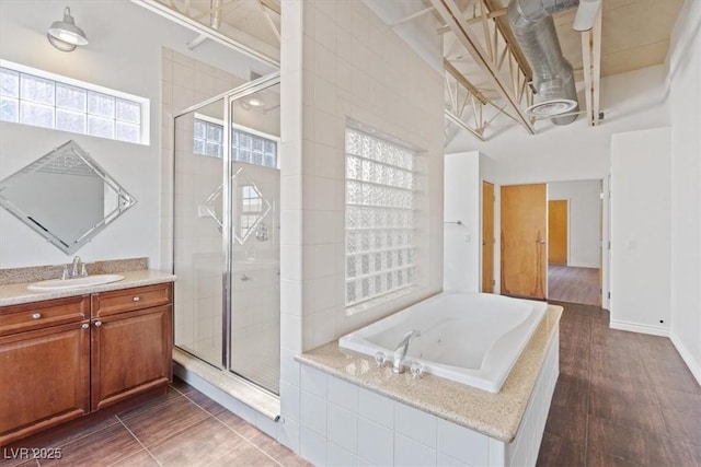 5603 Deer Creek Falls Ct, Las Vegas, NV 89118 - bathroom featuring vanity, a garden tub, a stall shower, and wood finished floors
