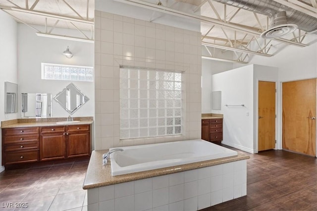 5603 Deer Creek Falls Ct, Las Vegas, NV 89118 - bathroom with vanity, a bath, and a towering ceiling