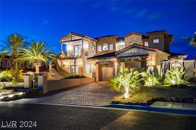 30 Via Tiberius Way, Henderson, NV 89011 - mediterranean / spanish-style home featuring decorative driveway, stone siding, a fenced front yard, and stucco siding