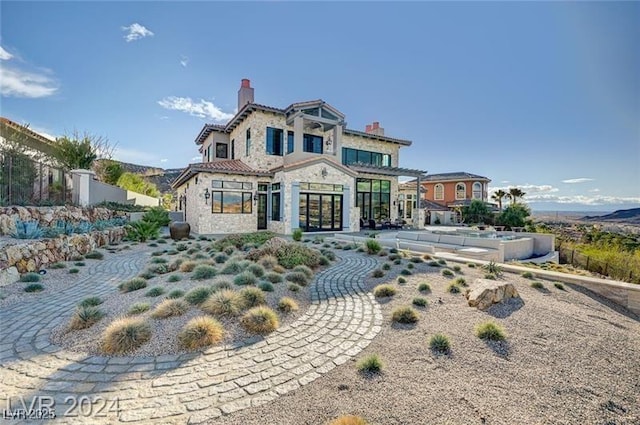 30 Via Tiberius Way, Henderson, NV 89011 - view of front facade with stone siding and a chimney