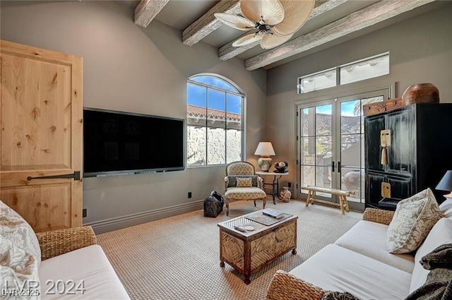 30 Via Tiberius Way, Henderson, NV 89011 - carpeted living room with beam ceiling, a ceiling fan, and plenty of natural light