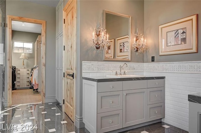30 Via Tiberius Way, Henderson, NV 89011 - bathroom with vanity, a chandelier, and a wainscoted wall