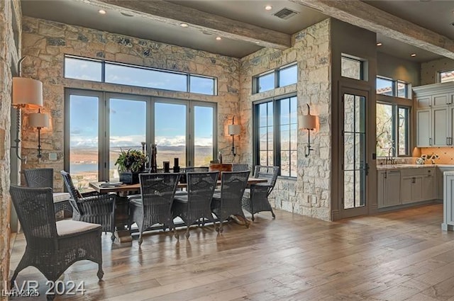 30 Via Tiberius Way, Henderson, NV 89011 - dining area with beamed ceiling, a high ceiling, and light wood-style flooring