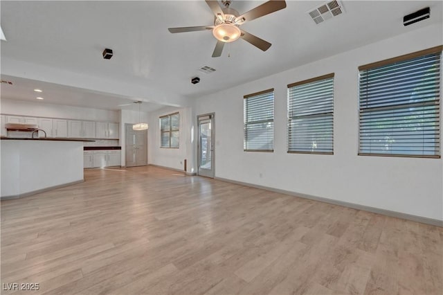 1069 Aspen Cliff Dr, Henderson, NV 89011 - unfurnished living room with light wood finished floors, ceiling fan, and recessed lighting