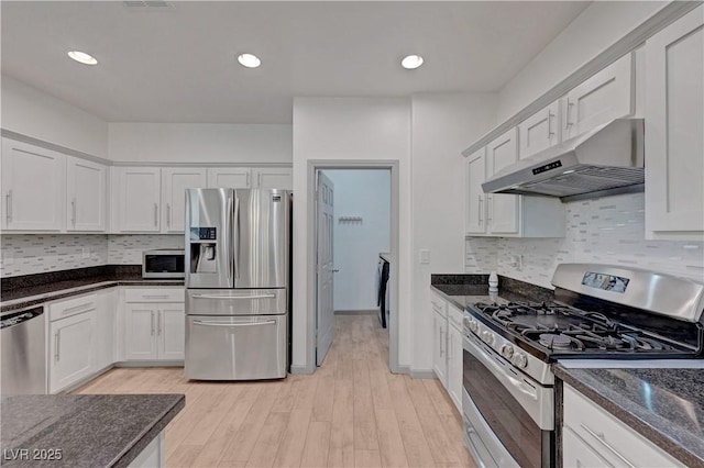 1069 Aspen Cliff Dr, Henderson, NV 89011 - kitchen with appliances with stainless steel finishes, under cabinet range hood, light wood-style floors, white cabinets, and recessed lighting