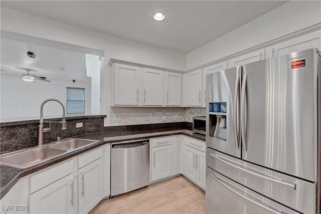 1069 Aspen Cliff Dr, Henderson, NV 89011 - kitchen with stainless steel appliances, ceiling fan, white cabinets, and recessed lighting