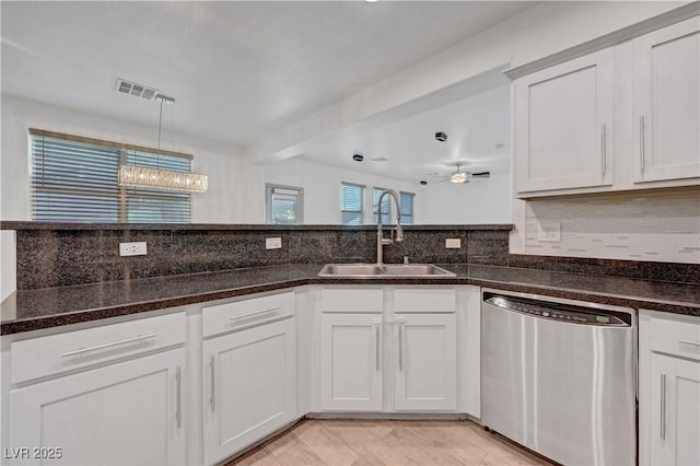 1069 Aspen Cliff Dr, Henderson, NV 89011 - kitchen with dishwasher, backsplash, ceiling fan, dark stone counters, and hanging light fixtures