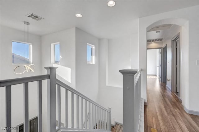 1069 Aspen Cliff Dr, Henderson, NV 89011 - corridor featuring an upstairs landing, plenty of natural light, arched walkways, wood finished floors, and recessed lighting