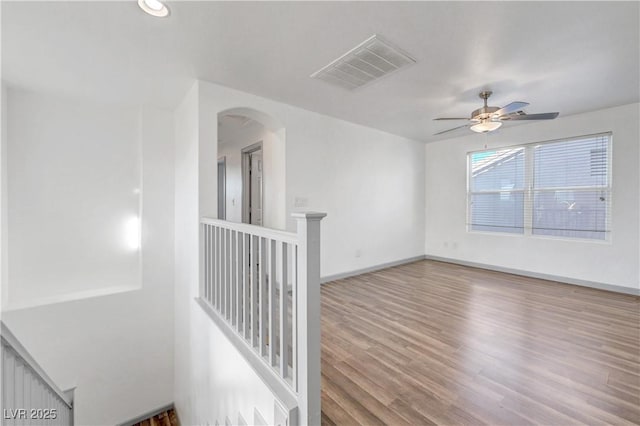1069 Aspen Cliff Dr, Henderson, NV 89011 - spare room with wood finished floors, arched walkways, ceiling fan, and recessed lighting