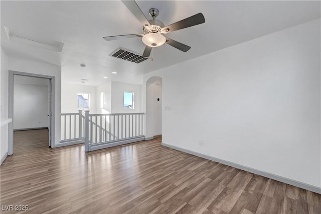 1069 Aspen Cliff Dr, Henderson, NV 89011 - empty room with wood finished floors, arched walkways, and a ceiling fan