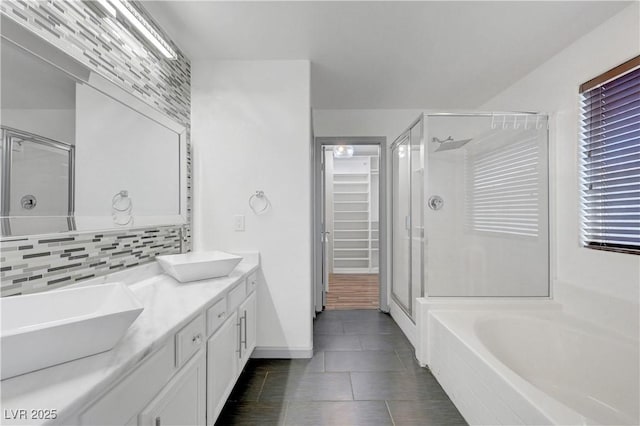 1069 Aspen Cliff Dr, Henderson, NV 89011 - bathroom with a stall shower, a garden tub, double vanity, tasteful backsplash, and tile patterned flooring