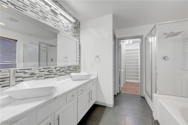 1069 Aspen Cliff Dr, Henderson, NV 89011 - bathroom with a shower stall, tile patterned flooring, double vanity, a spacious closet, and backsplash