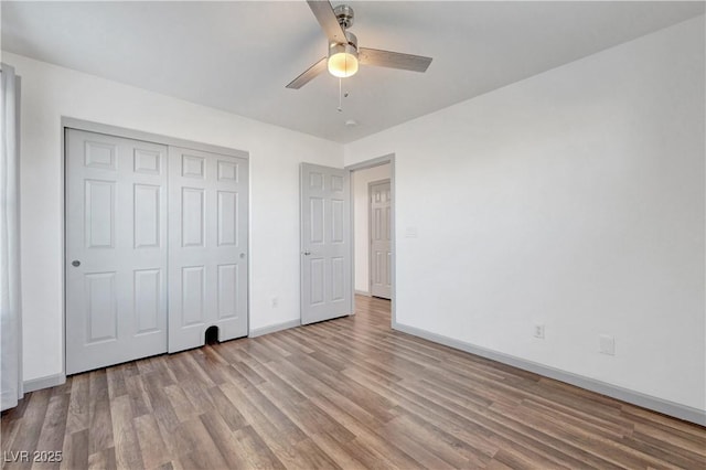 1069 Aspen Cliff Dr, Henderson, NV 89011 - unfurnished bedroom with wood finished floors, a closet, and a ceiling fan