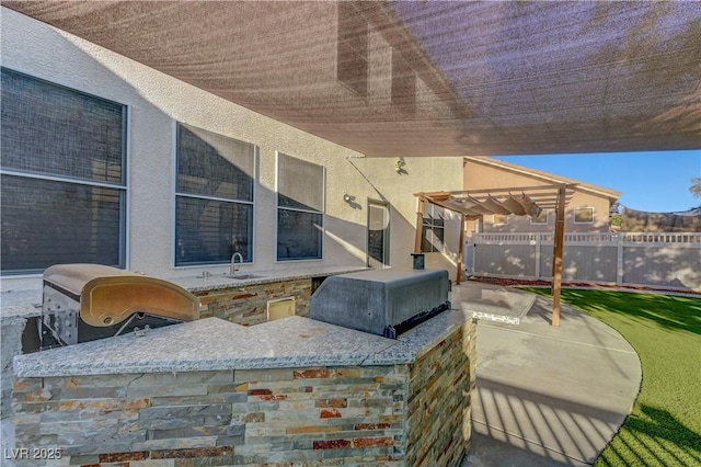 1069 Aspen Cliff Dr, Henderson, NV 89011 - view of patio with a pergola and exterior kitchen
