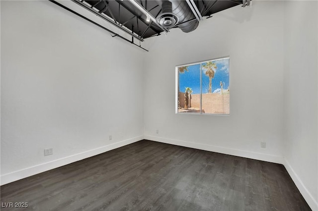 5015 Thunder River Cir, Las Vegas, NV 89148 - unfurnished room featuring baseboards and dark wood-style floors