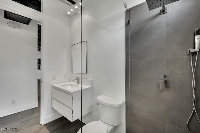 5015 Thunder River Cir, Las Vegas, NV 89148 - bathroom with vanity, tiled shower, and wood finished floors