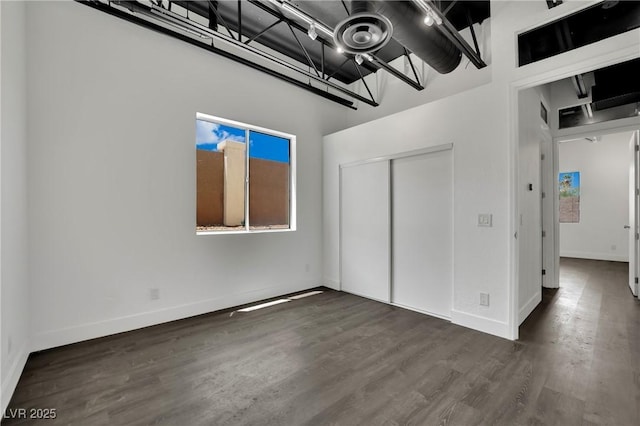 5015 Thunder River Cir, Las Vegas, NV 89148 - unfurnished bedroom featuring a closet, a chandelier, multiple windows, wood finished floors, and a towering ceiling
