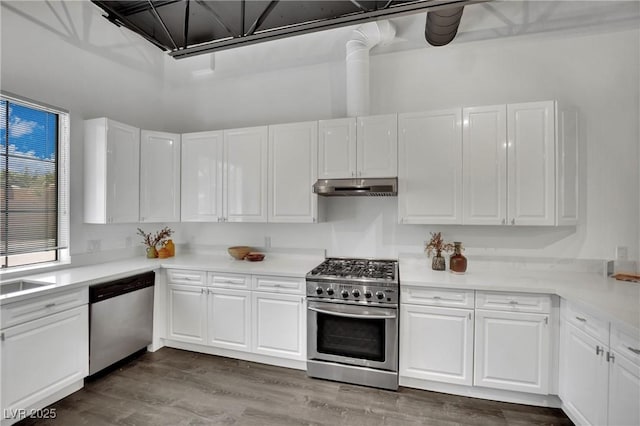 5015 Thunder River Cir, Las Vegas, NV 89148 - kitchen with appliances with stainless steel finishes, under cabinet range hood, white cabinets, and light countertops