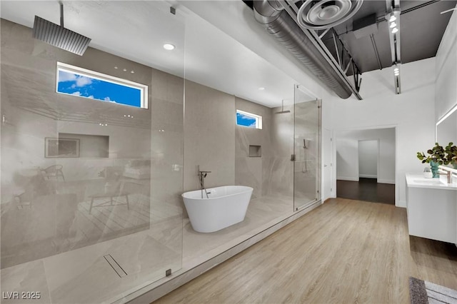 5015 Thunder River Cir, Las Vegas, NV 89148 - full bath featuring a stall shower, vanity, a soaking tub, and wood finished floors