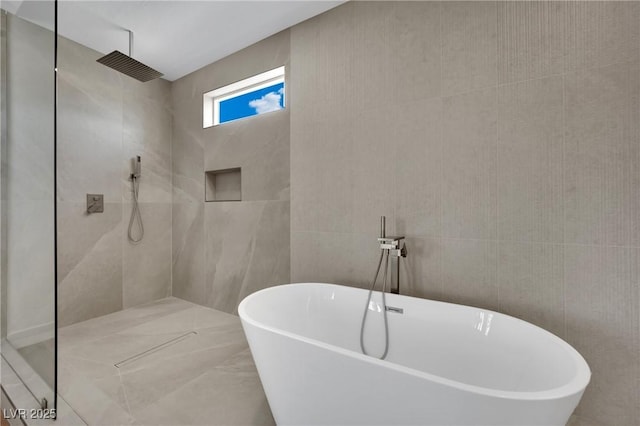 5015 Thunder River Cir, Las Vegas, NV 89148 - bathroom with walk in shower, a freestanding tub, and tile walls