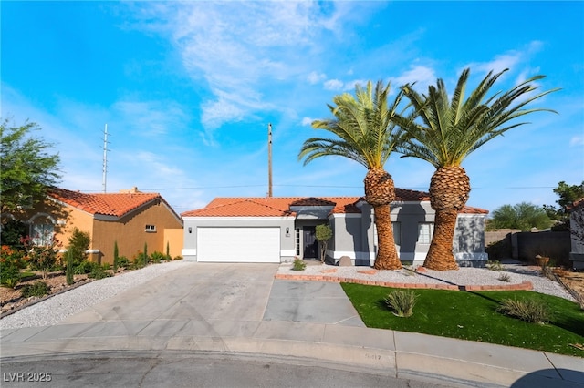 5417 Bible Cir, North Las Vegas, NV 89031 - view of front of house featuring a garage, a tile roof, stucco siding, and driveway