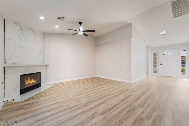5417 Bible Cir, North Las Vegas, NV 89031 - unfurnished living room featuring recessed lighting, a high end fireplace, a ceiling fan, and light wood-type flooring