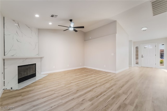 5417 Bible Cir, North Las Vegas, NV 89031 - unfurnished living room featuring recessed lighting, a high end fireplace, a ceiling fan, and light wood-style floors