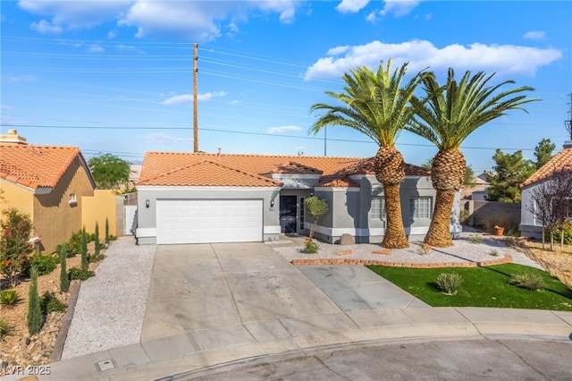 5417 Bible Cir, North Las Vegas, NV 89031 - view of front of house featuring stucco siding, a tiled roof, concrete driveway, and a garage