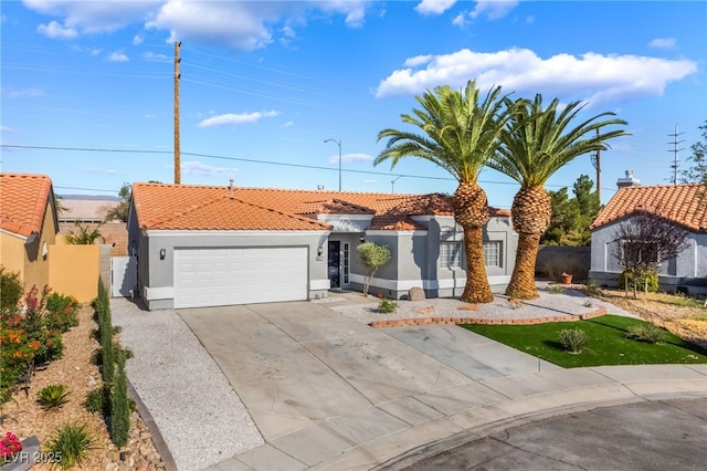 5417 Bible Cir, North Las Vegas, NV 89031 - view of front of house featuring stucco siding, a tiled roof, concrete driveway, and an attached garage