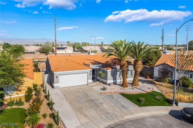 5417 Bible Cir, North Las Vegas, NV 89031 - view of front of property with a tile roof, concrete driveway, stucco siding, an attached garage, and a residential view