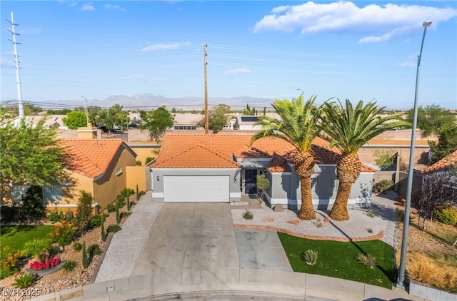 5417 Bible Cir, North Las Vegas, NV 89031 - mediterranean / spanish-style home with a tiled roof, a garage, stucco siding, concrete driveway, and a mountain view