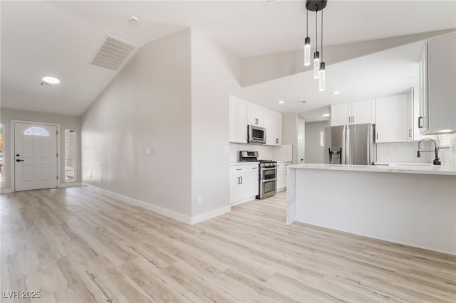 5417 Bible Cir, North Las Vegas, NV 89031 - kitchen with stainless steel appliances, tasteful backsplash, light countertops, a peninsula, and high vaulted ceiling