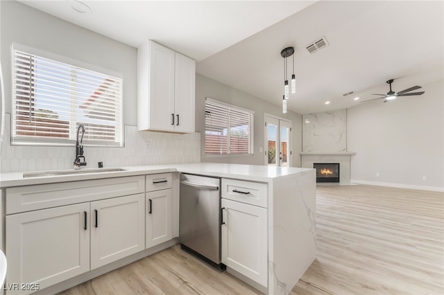 5417 Bible Cir, North Las Vegas, NV 89031 - kitchen with dishwasher, light wood-type flooring, white cabinets, light countertops, and a peninsula