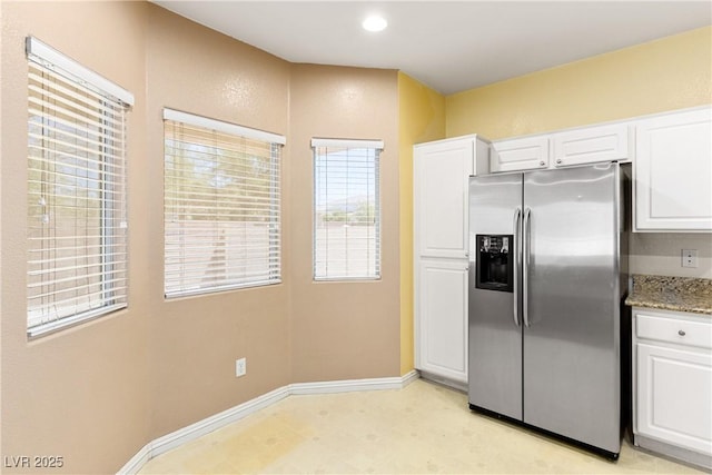 3828 Prairie Orchid Ave, North Las Vegas, NV 89081 - kitchen featuring stainless steel fridge with ice dispenser, white cabinetry, light stone countertops, light floors, and recessed lighting