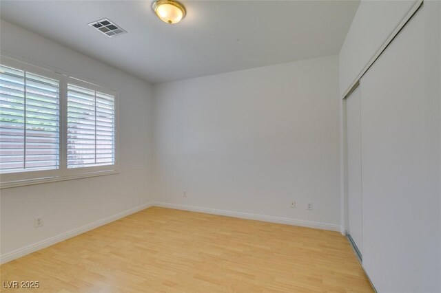 10513 Shanna Trellis Ave, Las Vegas, NV 89144 - unfurnished bedroom with light wood-style flooring and a closet