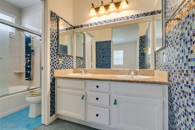 10513 Shanna Trellis Ave, Las Vegas, NV 89144 - bathroom with double vanity, shower / bath combination with glass door, tile patterned flooring, and tile walls