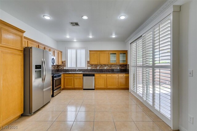 10513 Shanna Trellis Ave, Las Vegas, NV 89144 - kitchen with appliances with stainless steel finishes, dark countertops, backsplash, light tile patterned floors, and recessed lighting