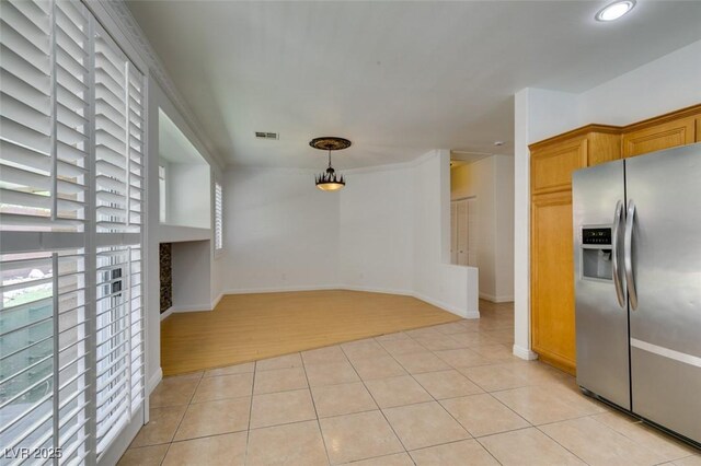 10513 Shanna Trellis Ave, Las Vegas, NV 89144 - kitchen with stainless steel refrigerator with ice dispenser, healthy amount of natural light, light tile patterned floors, and decorative light fixtures