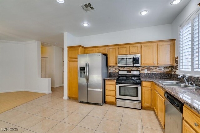 10513 Shanna Trellis Ave, Las Vegas, NV 89144 - kitchen with stainless steel appliances, tasteful backsplash, recessed lighting, dark stone countertops, and light tile patterned flooring