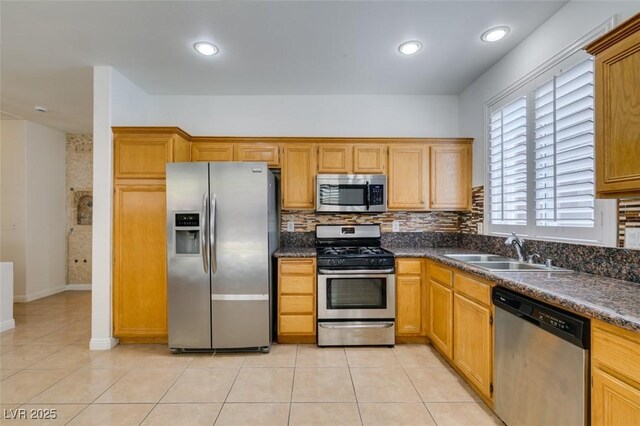 10513 Shanna Trellis Ave, Las Vegas, NV 89144 - kitchen with appliances with stainless steel finishes, dark countertops, backsplash, light tile patterned floors, and recessed lighting