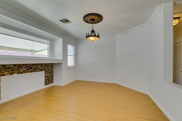 10513 Shanna Trellis Ave, Las Vegas, NV 89144 - unfurnished living room featuring light wood-style floors and ornamental molding