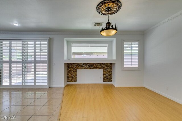 10513 Shanna Trellis Ave, Las Vegas, NV 89144 - unfurnished living room with a fireplace, light tile patterned flooring, and ornamental molding