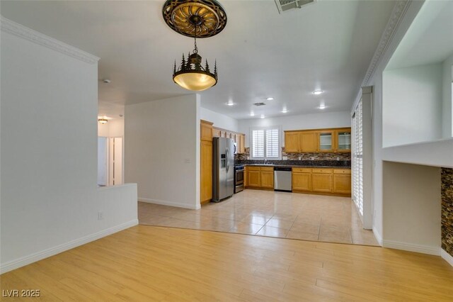 10513 Shanna Trellis Ave, Las Vegas, NV 89144 - kitchen featuring appliances with stainless steel finishes, dark countertops, light wood-type flooring, glass insert cabinets, and brown cabinetry