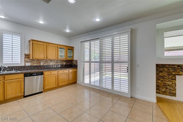 10513 Shanna Trellis Ave, Las Vegas, NV 89144 - kitchen with stainless steel dishwasher, brown cabinets, tasteful backsplash, and recessed lighting