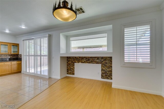 10513 Shanna Trellis Ave, Las Vegas, NV 89144 - unfurnished living room with light wood finished floors, crown molding, and recessed lighting