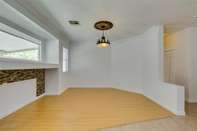 10513 Shanna Trellis Ave, Las Vegas, NV 89144 - unfurnished dining area with light wood-style flooring and baseboards