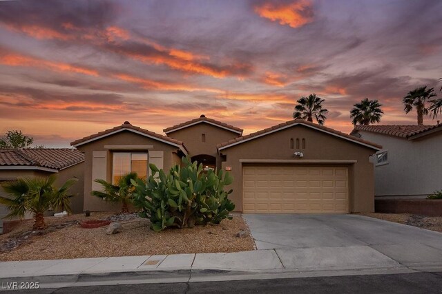10513 Shanna Trellis Ave, Las Vegas, NV 89144 - mediterranean / spanish home featuring a garage, concrete driveway, stucco siding, and a tile roof