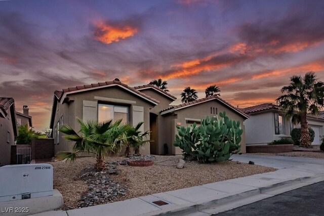 10513 Shanna Trellis Ave, Las Vegas, NV 89144 - mediterranean / spanish-style home with a tiled roof, an attached garage, stucco siding, and concrete driveway