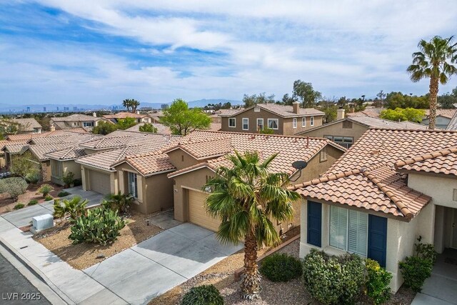 10513 Shanna Trellis Ave, Las Vegas, NV 89144 - mediterranean / spanish house with a residential view, a tiled roof, stucco siding, and concrete driveway